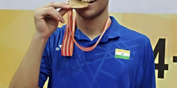 Lakshya Sen bites teh gold medal after beating Thailand's Kunlavut Vitidsaran in the Badminton Asia Junior Championships final, in Jakarta