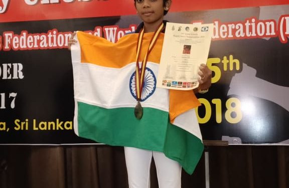 Arushi Srichandan poses with one of her medals and a certificate at Colombo, Saturday 