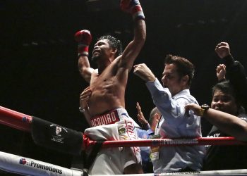 Manny Pacquiao (C) celebrates after defeating Argentina's Lucas Matthysse during their WBA World welterweight title bout in Kuala Lumpur