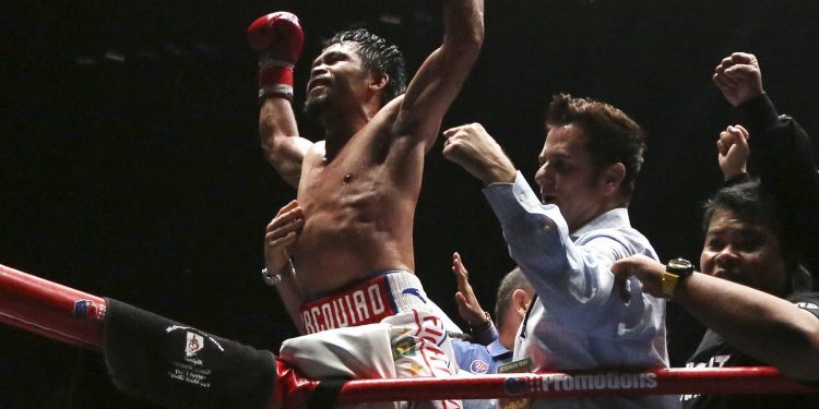 Manny Pacquiao (C) celebrates after defeating Argentina's Lucas Matthysse during their WBA World welterweight title bout in Kuala Lumpur