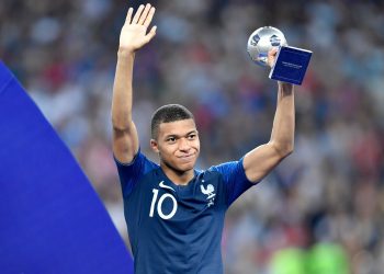 Teenage sensation: France’s Kylian Mbappe holds the ‘Best Young Player at the World Cup’ trophy aloft as he receives applause from fans after winning the tournament