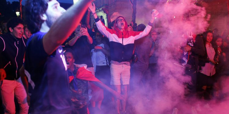 Parisians celebrate after France’s win over Belgium in the World Cup semifinals