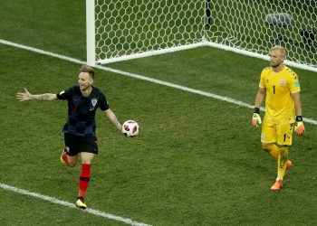 Ivan Rakitic wheels away in celebration after scoring the winning goal for Croatia with Danish goalkeeper Kasper Schmeichel on his hunches   