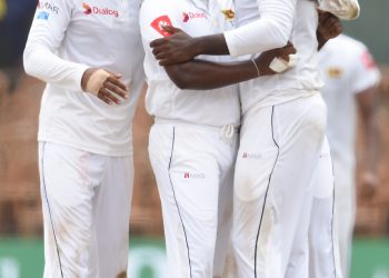 Rangana Herath celebrates with teammates after dismissing a South African batsman in Colombo, Monday
