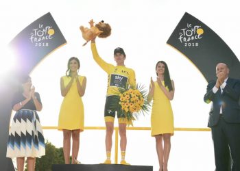 Geraint Thomas celebrates on the podium after winning the Tour de France title in Paris, Sunday