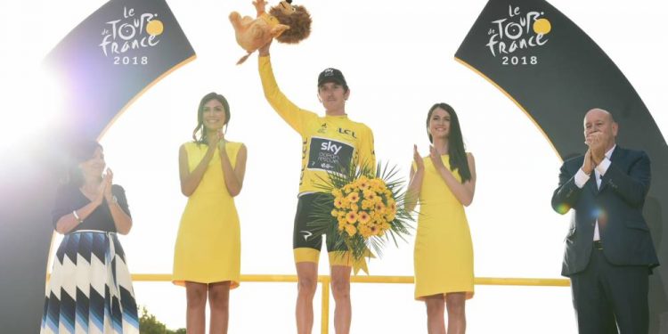 Geraint Thomas celebrates on the podium after winning the Tour de France title in Paris, Sunday