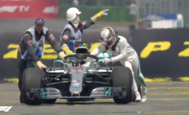 Lewis Hamilton pushes his car out of German qualifying