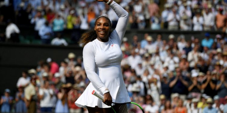 A smiling Serena Williams acknowledges the applause of the Wimbledon centre court crowd with the runner-up plate, Saturday