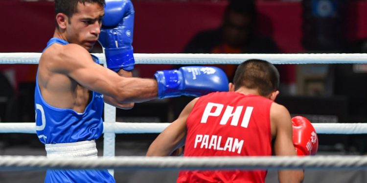 India’s Amit Phangal lands a punch during his bout against Philippines’ Carlo Paalam, Friday