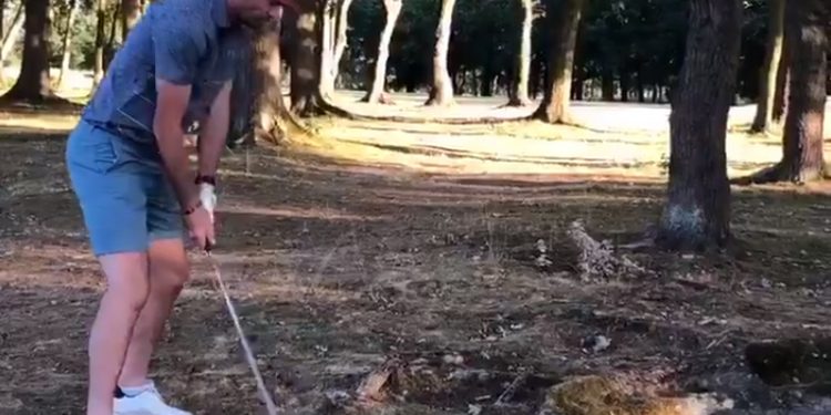 The shot that went awry: Jimmy Anderson about to hit the ball in Buckinghamshire, Sunday