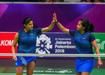 Ashwini Ponnappa (L) and N Sikki Reddy exchange high fives after their win, Thursday at the Asian Games