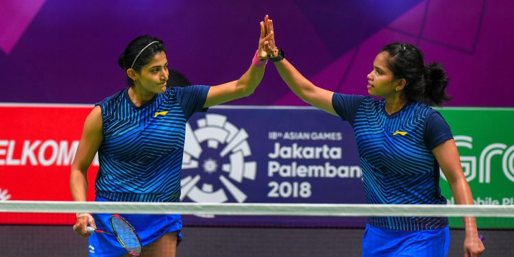 Ashwini Ponnappa (L) and N Sikki Reddy exchange high fives after their win, Thursday at the Asian Games