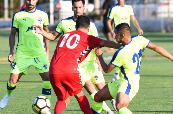 Bengaluru FC and Atletico Saguntino players tussle for the ball during their match, Friday