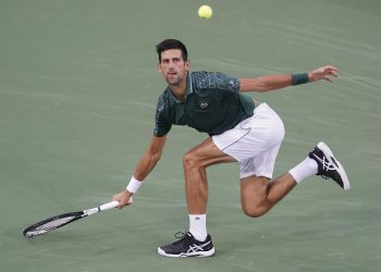 Novak Djokovic runs down a shot from Grigor Dimitrov at the Cincinnati Masters tennis tournament