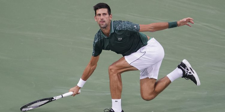 Novak Djokovic runs down a shot from Grigor Dimitrov at the Cincinnati Masters tennis tournament