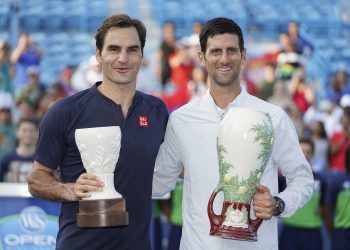 Novak Djokovic (R) and Roger Federer poses with their respective trophies after the final at Cincinnati, Sunday
