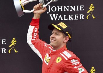 Ferrari driver Sebastian Vettel jubilates with his trophy on the podium after winning the Belgian Grand Prix Spa-Francorchamps