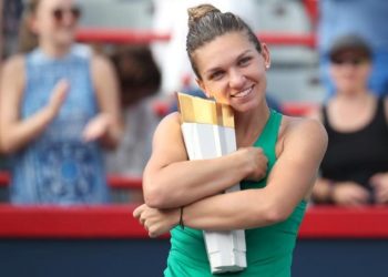 Simona Halep poses with the winner’s trophy in Montreal, Sunday