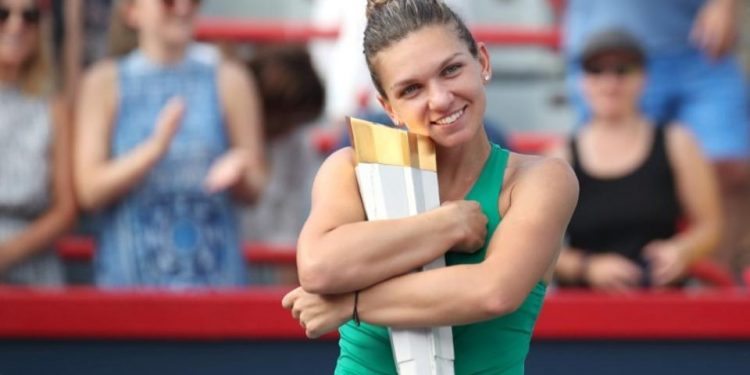 Simona Halep poses with the winner’s trophy in Montreal, Sunday