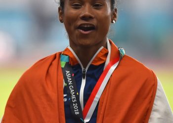 Indian athlete Hima Das celebrates after securing silver medal in the women's 400m final on Athletics track event at the Asian Games