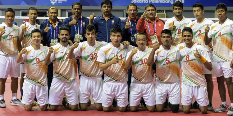 Indian Sepaktakraw team players along with the officials pose for a group photo after winning the first ever Asian Games bronze medal at Jakarta