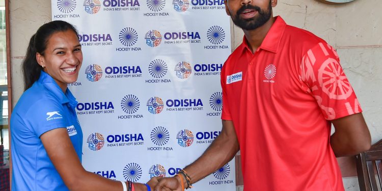 Skipper of the Indian women’s hockey team Rani wishes luck to his men’s team counterpart before the departure of the teams for the Asian Games in Indonesia  