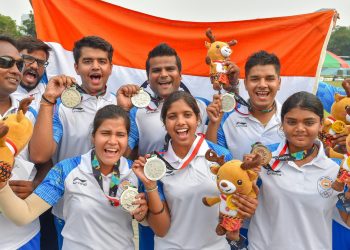 Indian men's and women's archery team members display their silver medals at the Asian Games in Jakarta