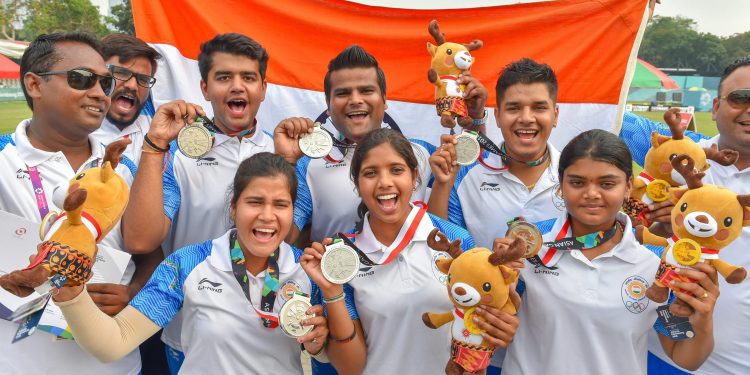 Indian men's and women's archery team members display their silver medals at the Asian Games in Jakarta