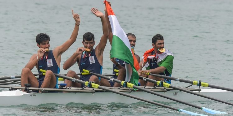 Indian rowing Men's team members Sawarn Singh, Bhokanal Dattu, Om Prakash and S Singh celebrate after the medal ceremony winning the gold medal during the Asian Games