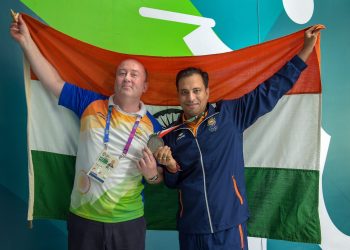 Sanjeev Rajput celebrates with coach Oleg Mikhalov after winning the Silver medal in men's 50m rifle 3 position shooting at the Asian Games