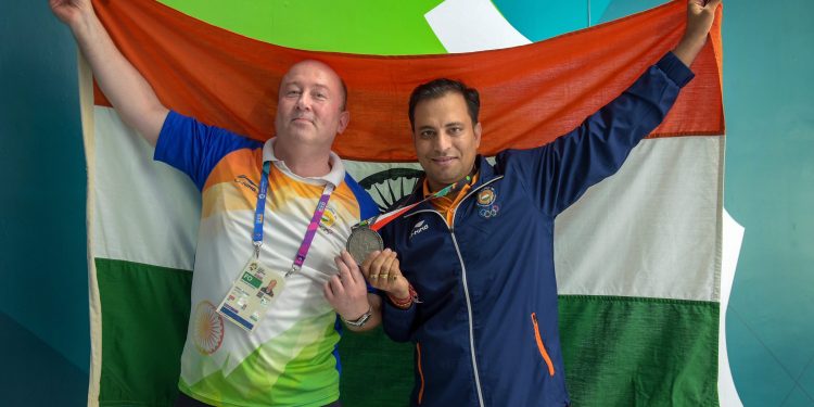 Sanjeev Rajput celebrates with coach Oleg Mikhalov after winning the Silver medal in men's 50m rifle 3 position shooting at the Asian Games