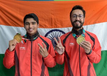 Gold medal winner Saurav Chaudhary (L) and bronze medallist Abhishek Verma pose for photographs during the medal presentation ceremony of men's 10m air pistol event at the Asian Games in Palembang