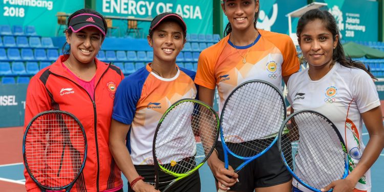 Indian women's tennis team members Ankita Raina, Karman Kaur and Prarthna with their coach Ankita Bhambri (L) pose for a photo after a practice session at Palembang in Indonesia Friday