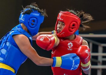 Naorem Roshibina Devi (red) fights China's Cai Yingying at the Asian Games in Jakarta