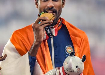 Gold medallist athlete Jinson Johnson poses for photographs during the medal ceremony for the men's 1500m event