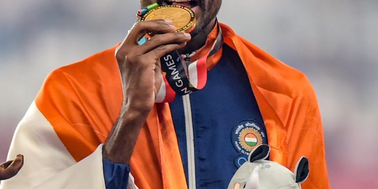 Gold medallist athlete Jinson Johnson poses for photographs during the medal ceremony for the men's 1500m event