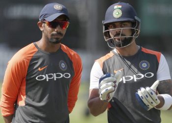 Jasprit Bumrah (L) listens as Virat Kohli explains a point during India’s training session Tuesday at Lord’s