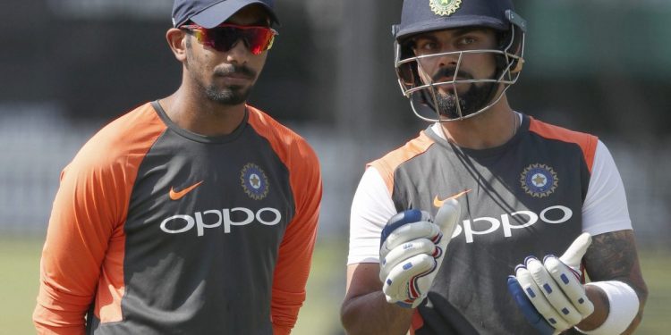 Jasprit Bumrah (L) listens as Virat Kohli explains a point during India’s training session Tuesday at Lord’s