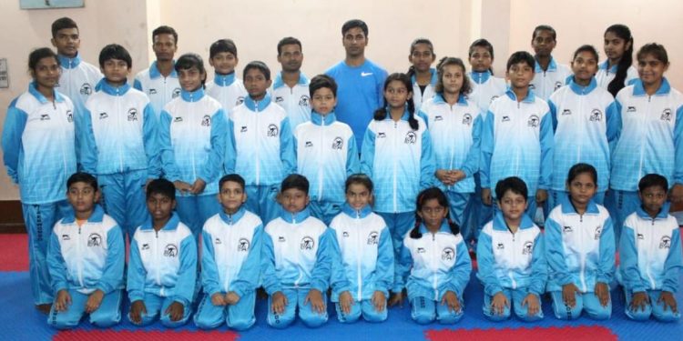 Berhampur taekwondo players pose for a photograph Thursday before their departure to Cuttack   