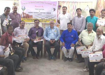 Winners of the Invitational Senior Citizen Chess Championship pose with their trophies and certificates along with guests in Cuttack, Friday