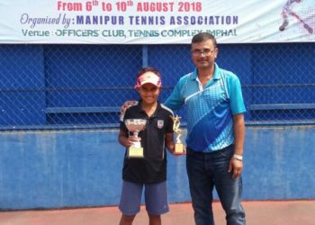 Sohini S Mohanty poses with her trophies along with an official at Manipur, Thursday