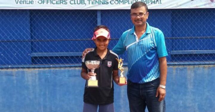 Sohini S Mohanty poses with her trophies along with an official at Manipur, Thursday