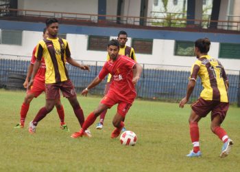 A Mangala Club player (in red) tries to get past Rovers Club defenders during their match at Barabati Stadium in Cuttack, Thursday    