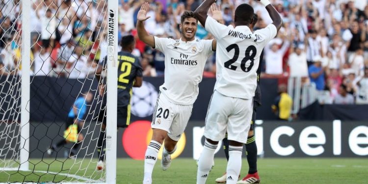 Marco Asensio (20) joins teammate Vinicius Jr for celebration after scoring Real Madrid’s second goal against Juventus, Saturday
