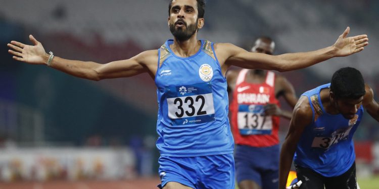 India's Manjit Singh celebrates as he crosses the finish line to win the men's 800m final at the Asian Games in Jakarta