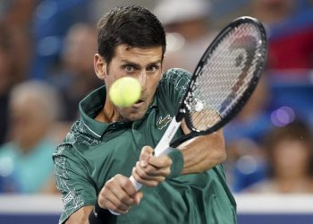 Novak Djokovic returns to Steve Johnson in the first round of the Cincinnati Open tennis tournament