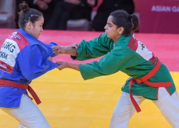 Megha Tokas (green) competes with Turkmenistan's Gulshat Nasyrova in women's 63kg Kurash at Jakarta