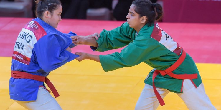 Megha Tokas (green) competes with Turkmenistan's Gulshat Nasyrova in women's 63kg Kurash at Jakarta