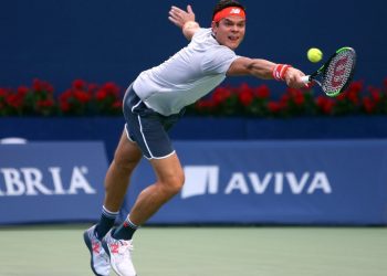 Milos Raonic stretched to hit a backhand during his first round match against David Goffin at Toronto, Monday