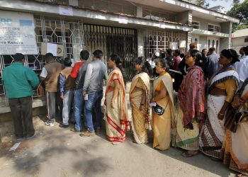 People queue outside NRC Seva Kendra to check names of themselves and family members in a draft for National Register of Citizens (NRC) in Guwahati on Monday.  PTI Photo (PTI1_1_2018_000061B)